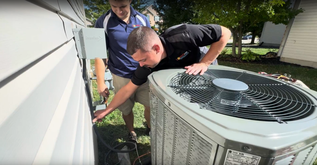 Logan Services technician installing an AC unit.